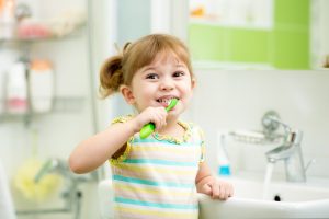 Kd,girl,brushing,teeth,in,bath,room