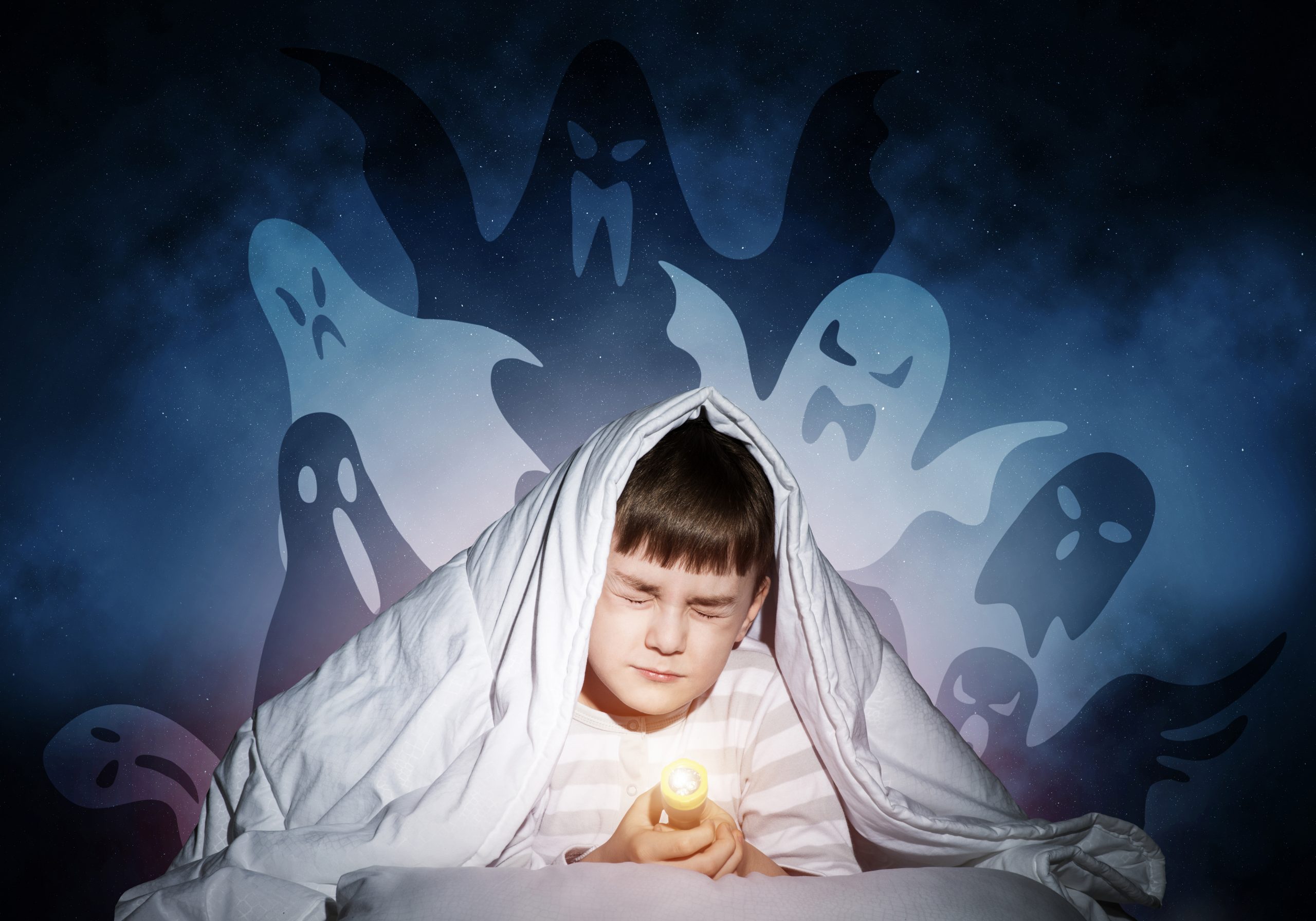 Young,boy,hiding,under,blanket,from,imaginary,ghosts.,scared,kid