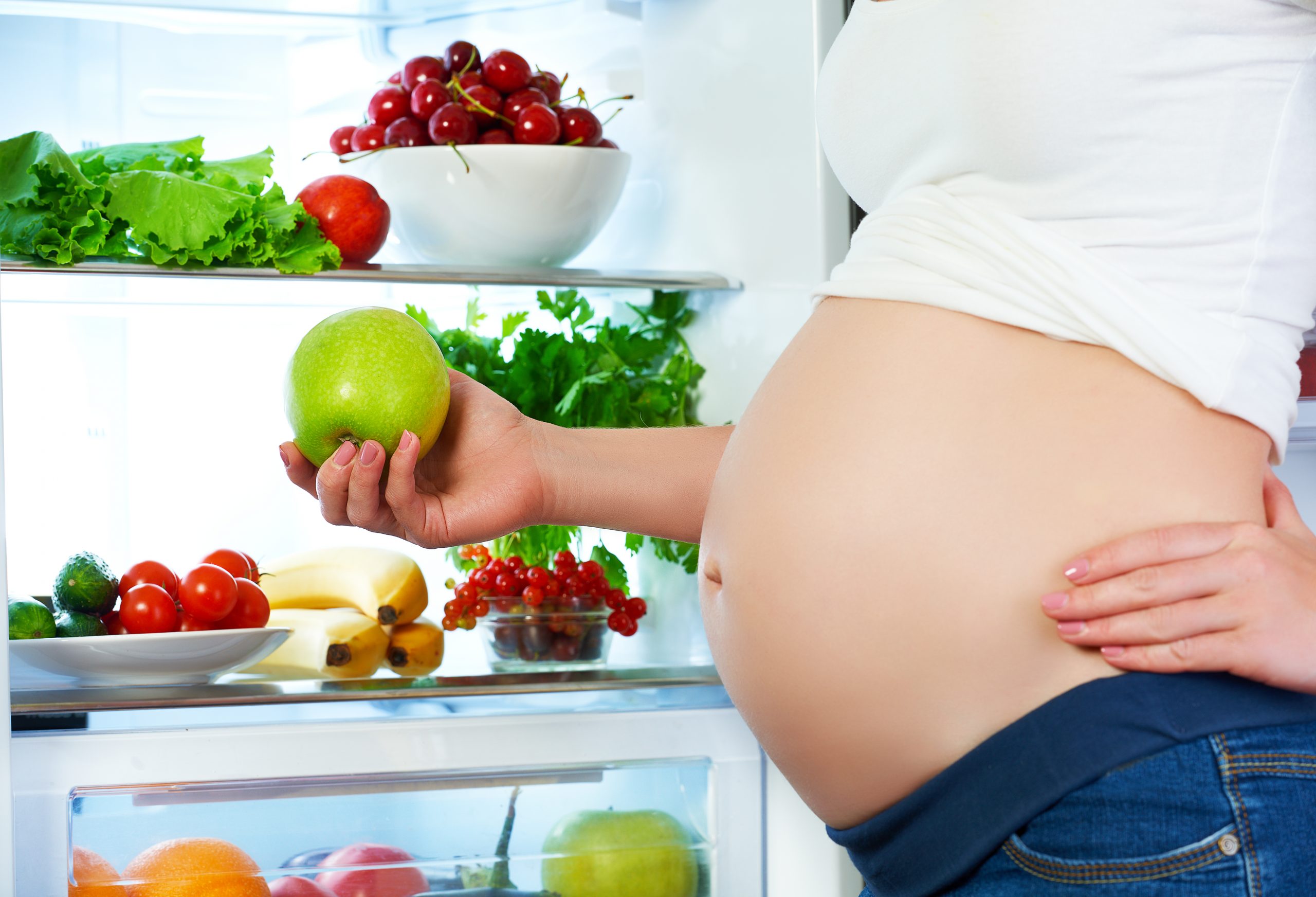 Nutrition,and,diet,during,pregnancy.,pregnant,woman,standing,near,refrigerator