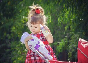 Girl,with,a,doll.,a,game.,selective,focus.