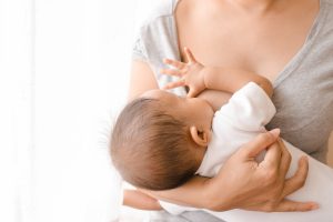 Mother,breastfeeding,her,newborn,baby,beside,window.,milk,from,mom’s