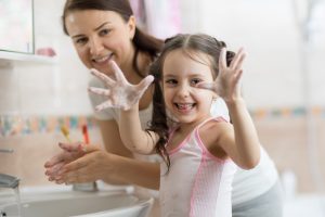 Child,girl,and,mother,washing,hands,with,soap,in,bathroom