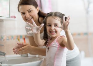 Child,girl,and,mother,washing,hands,with,soap,in,bathroom